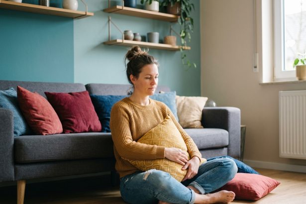 Femme assise sur le sol dans un salon moderne avec coussins colorés